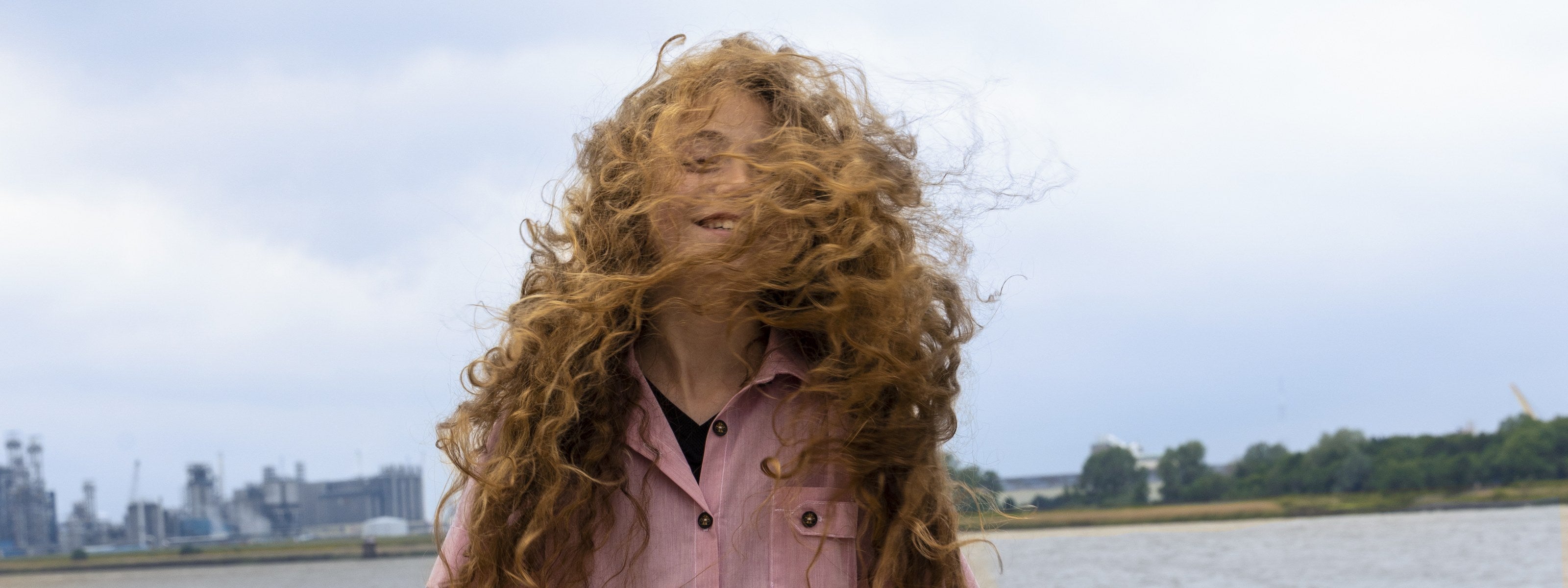 The Vacation Edit – girl in pink hand-painted dress on a windy beach – Infantium Victoria